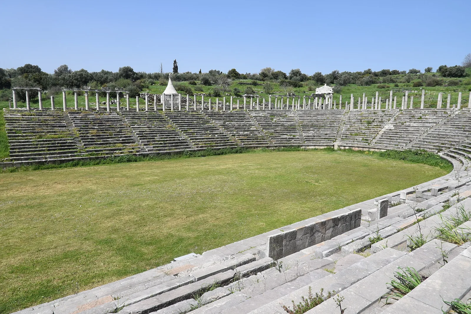 Colonnades and seating surrounding the stadium at ancient Messene.