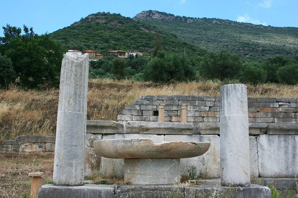 Ruins at ancient Messene with the village of Mavromati and hills beyond.