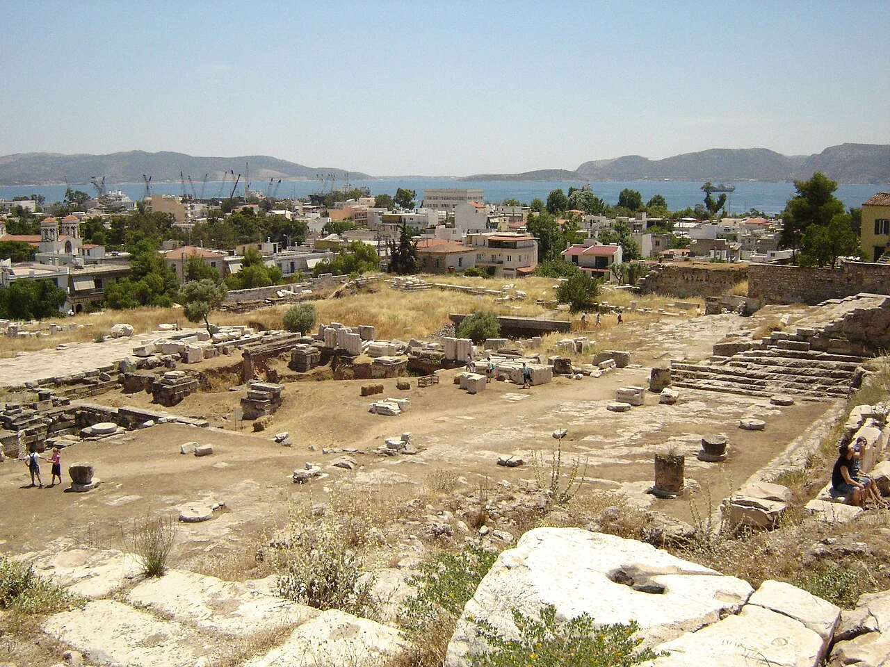 Archaeological remains at Eleusis with the modern town and sea beyond